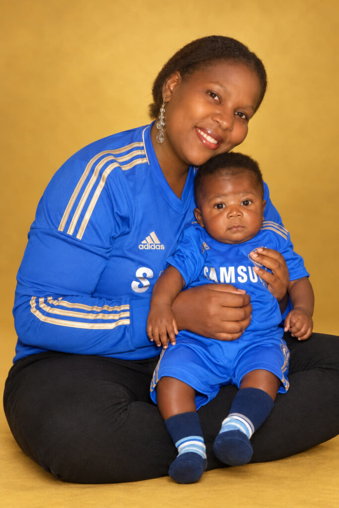 David Shelton as a baby, sitting on the lap of his mother, Shema Mukasi