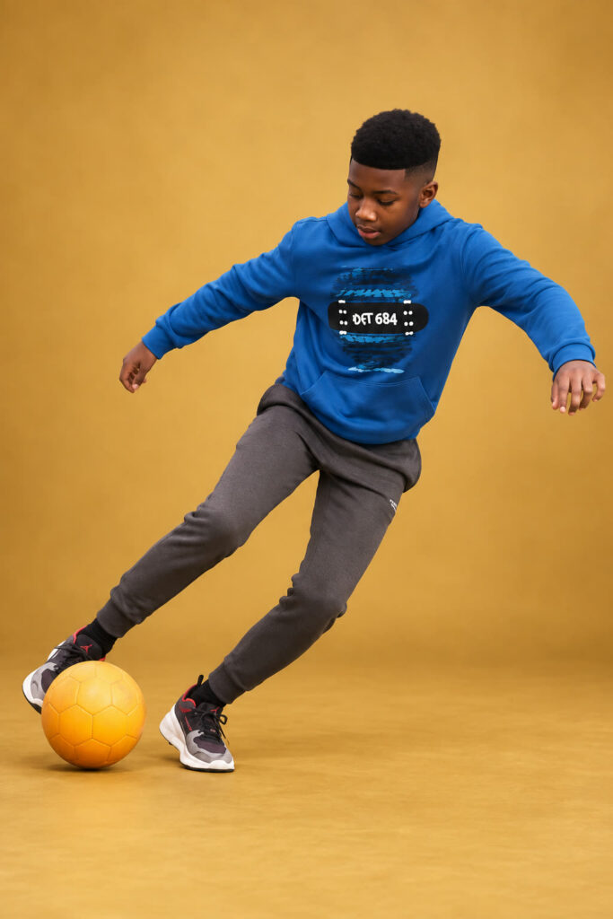 David Shelton, now a teenager, dribbling a football